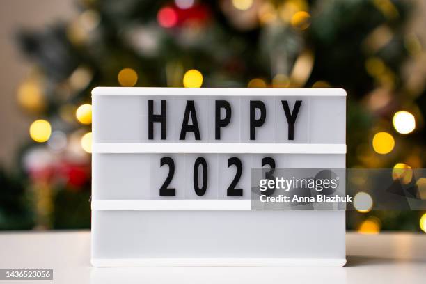 happy 2023 new year symbol, blurred lights in background - caixa de luz - fotografias e filmes do acervo