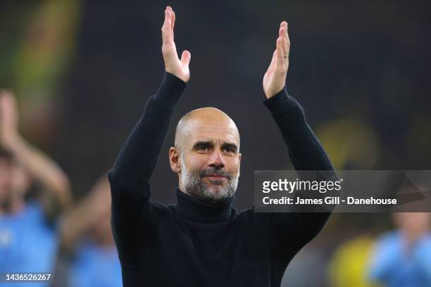 Pep Guardiola the manager of Manchester City reacts towards their support after the UEFA Champions League group G match between Borussia Dortmund and...