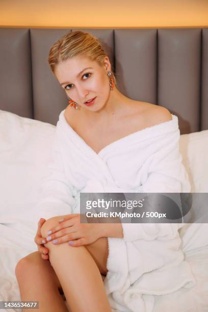 pretty blonde female in a white bathrobe kmphoto - kmphoto stock pictures, royalty-free photos & images