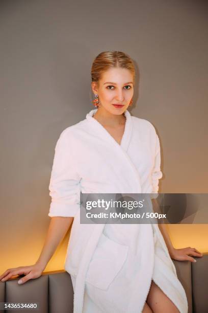 pretty blonde female in a white bathrobe kmphoto - kmphoto stock pictures, royalty-free photos & images