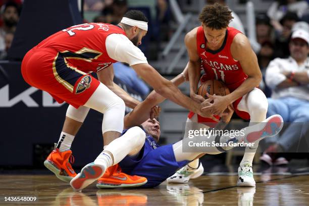 Dyson Daniels and Larry Nance Jr. #22 of the New Orleans Pelicans steals the ball from Luka Doncic of the Dallas Mavericks during the first quarter...