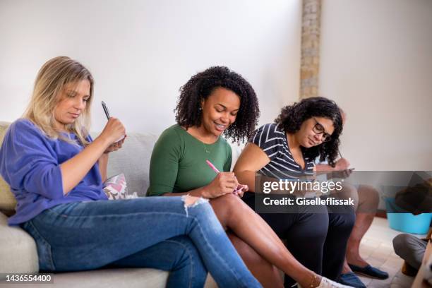 friends playing leisure games at home - jogo de palavras imagens e fotografias de stock