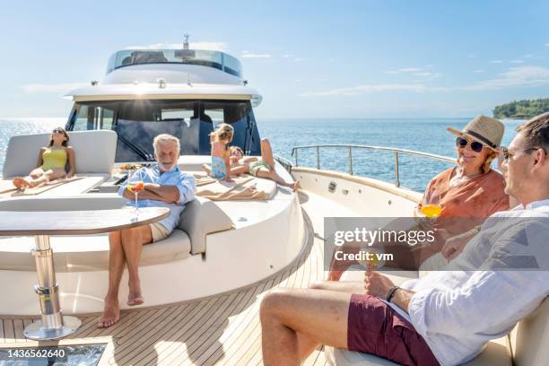 multigenerational family enjoying cruise on yacht on sunny day - yacht bildbanksfoton och bilder