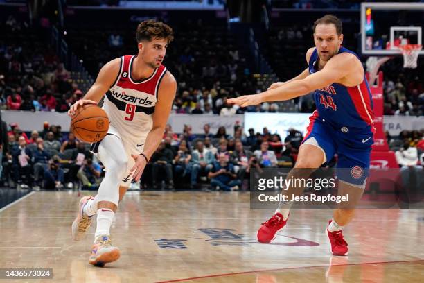 Deni Avdija of the Washington Wizards drives against Bojan Bogdanovic of the Detroit Pistons in the second half at Capital One Arena on October 25,...