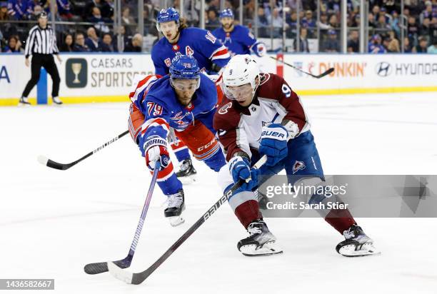 Evan Rodrigues of the Colorado Avalanche controls the puck as K'Andre Miller of the New York Rangers defends during the third period at Madison...