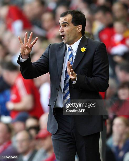 Wigan's Spanish manager Roberto Martinez gestures during the English Premier League football match between Liverpool and Wigan Athletic at Anfield in...