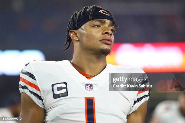 Justin Fields of the Chicago Bears stretches prior to an NFL football game against the New England Patriots at Gillette Stadium on October 24, 2022...
