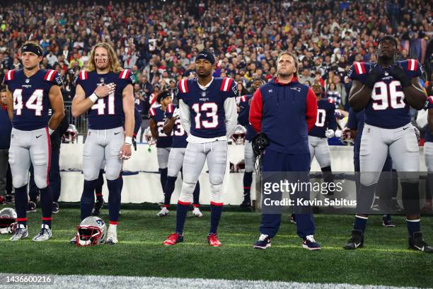 Ron'Dell Carter, Brenden Schooler, Jack Jones, outside linebackers coach Stephen Belichick, and Sam Roberts of the New England Patriots stand on the...