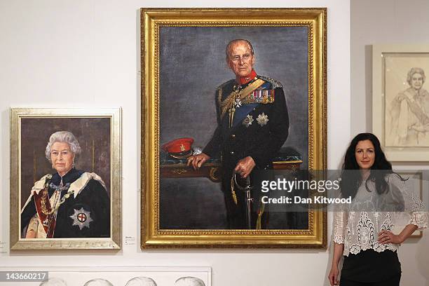 Jemma Phipps poses besides her new portrait of Prince Philip, Duke of Edinburgh during a photocall for the Royal Society of Portrait Painters...