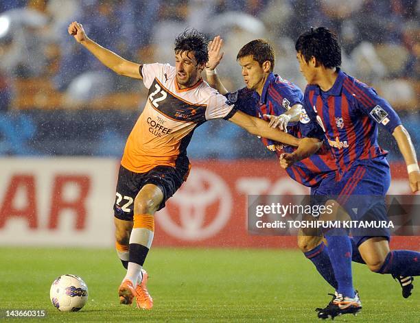 Brisbane Roar midfielder Thomas Broich fights for the ball with FC Tokyo midfielder Ariajasuru Hasegawa during their AFC Champions League Group F...