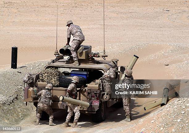 Soldiers load their military vehicle with rockets during manoeuvres with the French army in the desert of Abu Dhabi May 2, 2012. AFP PHOTO/KARIM SAHIB