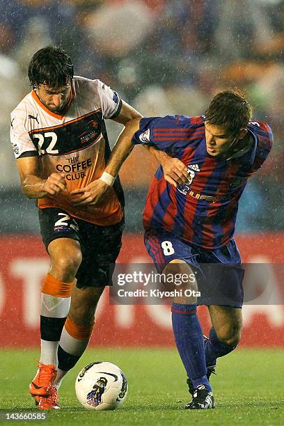 Thomas Broich of the Roar and Aria Jasuru Hasegawa of FC Tokyo contest the ball during the AFC Asian Champions League Group F match between FC Tokyo...