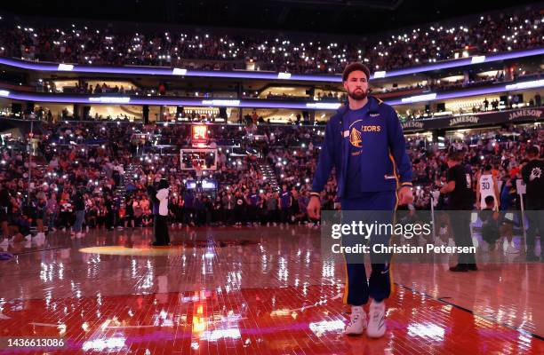 Klay Thompson of the Golden State Warriors stands on the court before the start of the NBA game against the Phoenix Suns at Footprint Center on...