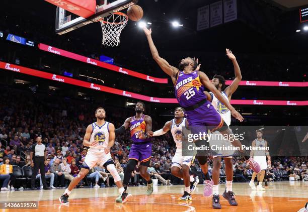 Mikal Bridges of the Phoenix Suns lays up a shot ahead of Andrew Wiggins of the Golden State Warriorsduring the second half of the NBA game at...