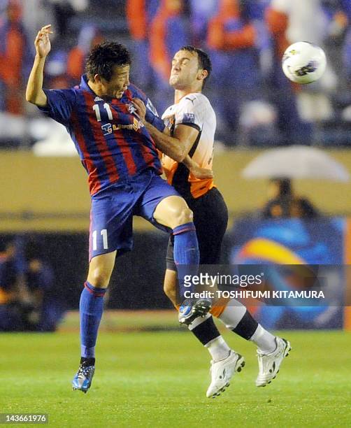 Tokyo forward Kazuma Watanabe fights for the ball with Brisbane Roar defender Ivan Franjic during their AFC Champions League Group F match in Tokyo...