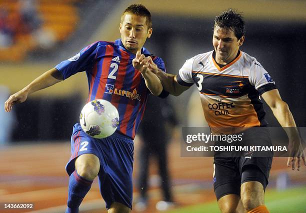 Tokyo defender Yuhei Tokunaga fights for the ball with Brisbane Roar defender Shane Stefanutto during their AFC Champions League Group F match in...