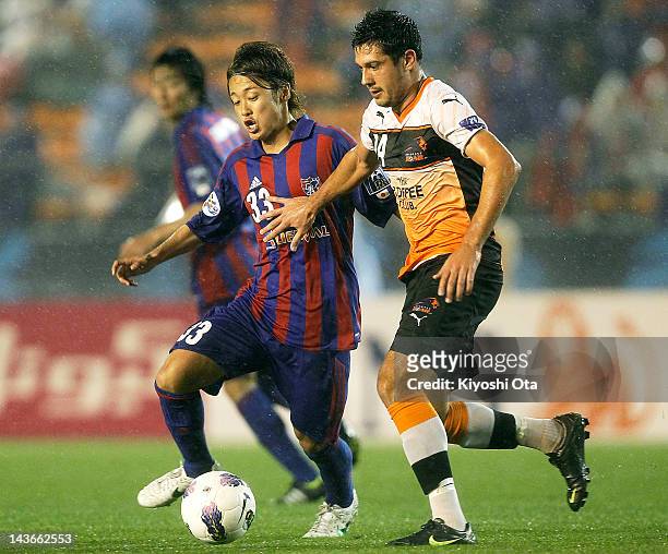 Rocky Visconte of the Roar and Kenta Mukuhara of FC Tokyo contest the ball during the AFC Asian Champions League Group F match between FC Tokyo and...