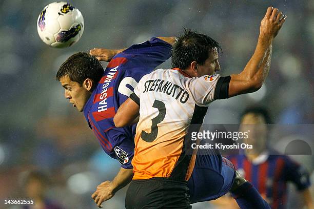 Aria Jasuru Hasegawa of FC Tokyo and Shane Stefanutto of the Roar battle for the ball during the AFC Asian Champions League Group F match between FC...