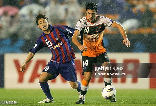 Rocky Visconte of the Roar controls the ball against Kenta Mukuhara of FC Tokyo during the AFC Asian Champions League Group F match between FC Tokyo...