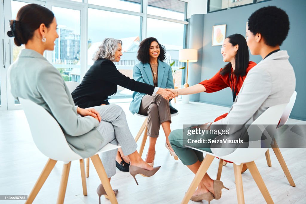 Handshake, meeting and collaboration with a team of business people in agreement in the office. Thank you, partnership and b2b with a female leader and employee shaking hands for teamwork or unity