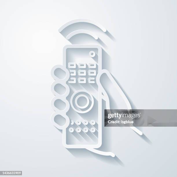 hand with remote control. icon with paper cut effect on blank background - holding remote control stock illustrations