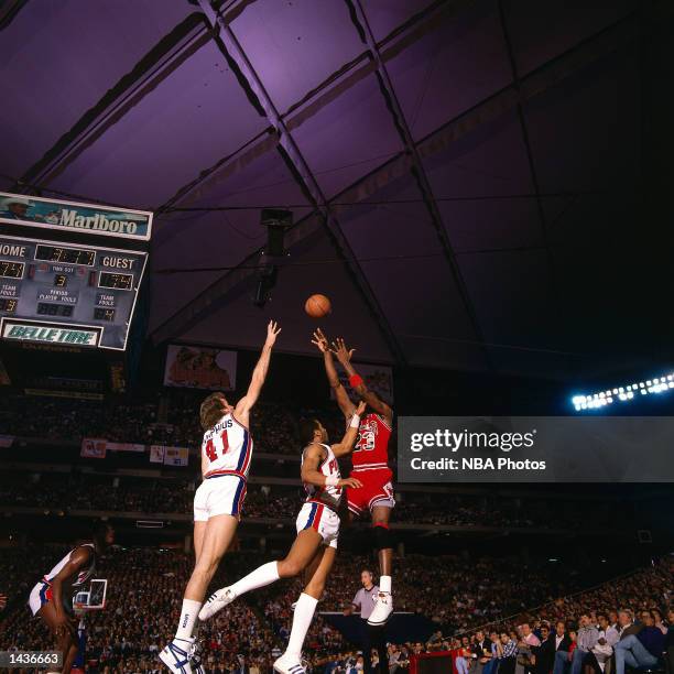 Michael Jordan of the Chicago Bulls shoots a jumpshot against the Detroit Piston in 1987 during the NBA game at The Pontiac Silverdome in Detroit,...