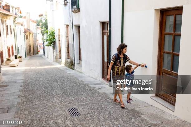 mother and son playing on the street - portugal travel stock pictures, royalty-free photos & images