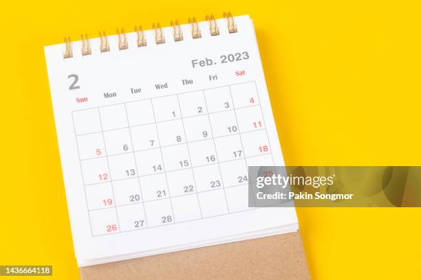 calendar desk 2023: february is the month for the organizer to plan and deadline with a yellow paper background. - februar stock-fotos und bilder