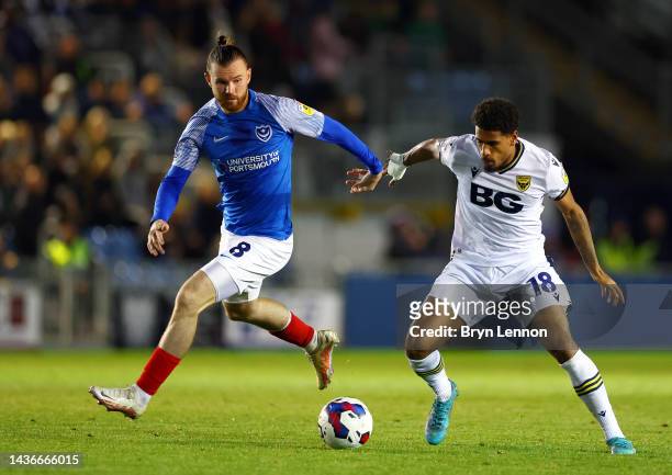 Ryan Tunnicliffe of Portsmouth challenges Marcus McGuane of Oxford United during the Sky Bet League One between Portsmouth and Oxford United at...