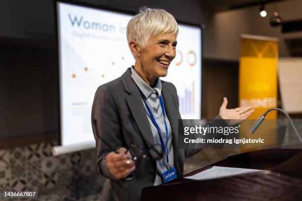 successful businesswoman having a speech during business conference - emcee stockfoto's en -beelden