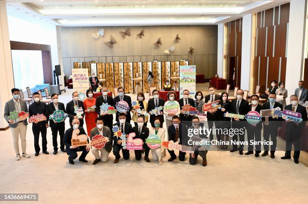 Lawmakers hold signs to encourage residents to get flu shots at the Legislative Council on October 26, 2022 in Hong Kong, China.