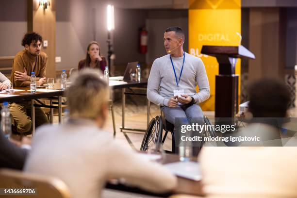 businessman having a speech during business conference in lecture hall - compere stock pictures, royalty-free photos & images