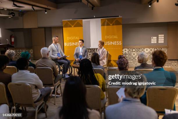 business people on panel discussion in convention center - health seminar stock pictures, royalty-free photos & images