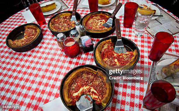 Deep dish pizza sits on a table at Gino's East restaurant in Chicago, Illinois, U.S., on Wednesday, April 18, 2012. U.S. Restaurant-industry sales...