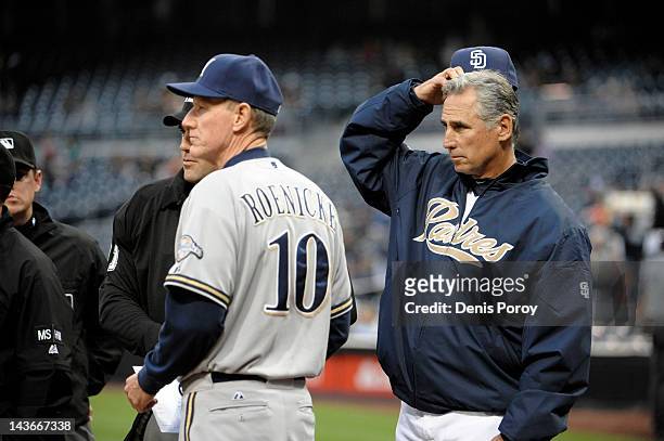 Manager Ron Roenicke of the Milwaukee Brewers and manager Bud Black of the San Diego Padres meet with the umpires before a baseball game at Petco...