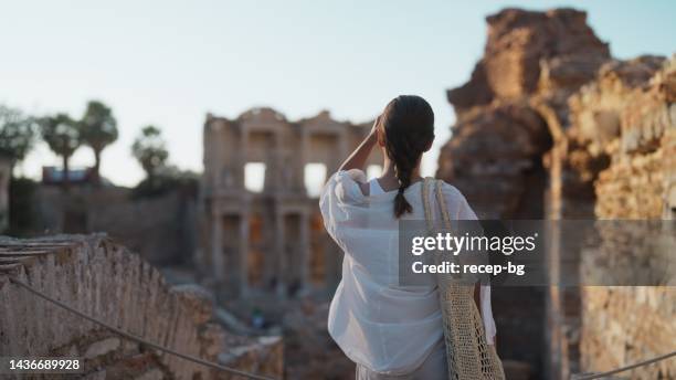 young female tourist taking a walk in historical ancient old town - ephesus stock pictures, royalty-free photos & images