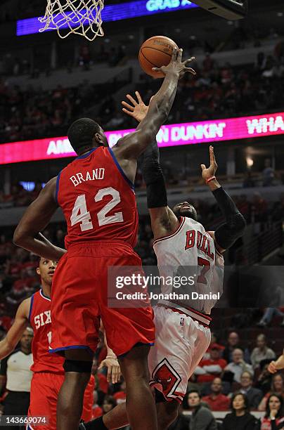 Elton Brand of the Philadelphia 76ers leaps to block a shot by C.J. Watson of the Chicago Bulls in Game Two of the Eastern Conference Quarterfinals...