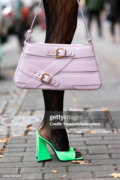 Marina Hoermanseder wearing logo tights by Gucci, neon green mules by The Attico and a pastel lavender bag by Marina Hoermanseder x weat during a...