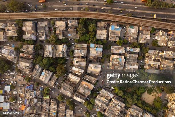 4k drone view of over populated residential colonies of tilak nagar, with elevated delhi metro tracks, west delhi, new delhi - stock photo - new delhi stock photos et images de collection