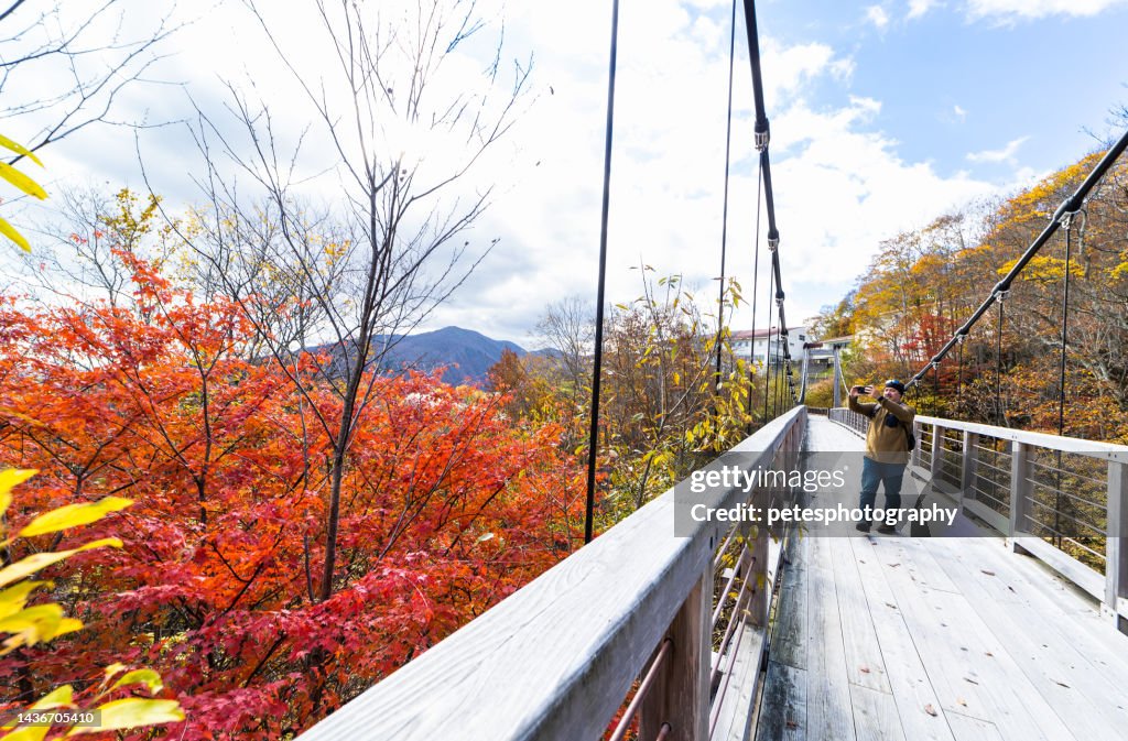 A traveler in Japan exploring the outdoors on wood bridge