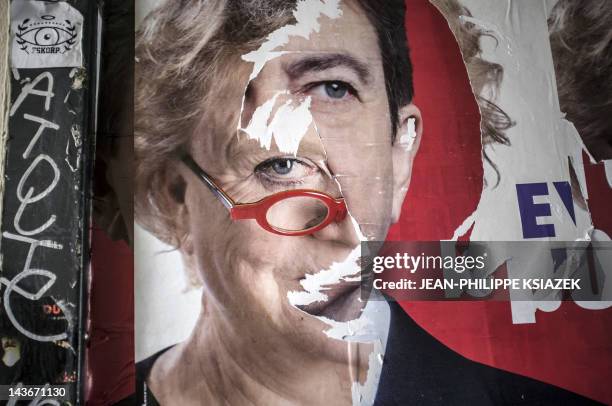Picture of torn campaign posters of French Green Party "Europe Ecologie Les Verts" candidate Eva Joly and of Front de gauche leftist candidate...