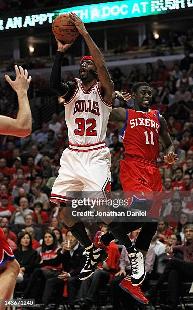 Richard Hamilton of the Chicago Bulls shoots past Jrue Holiday of the Philadelphia 76ers in Game Two of the Eastern Conference Quarterfinals during...