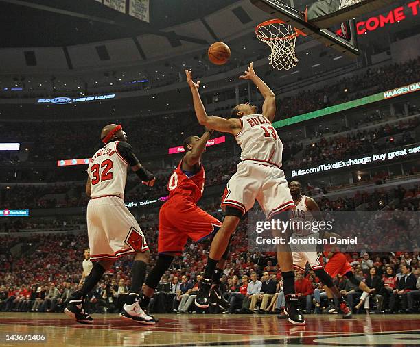 Joakim Noah of the Chicago Bulls rebounds over teammate Richard Hamilton and Lavoy Allen of the Philadelphia 76ers in Game Two of the Eastern...