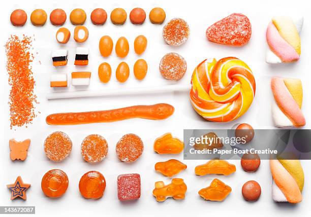 graphic layout of orange sweets and candy - gummi stock pictures, royalty-free photos & images