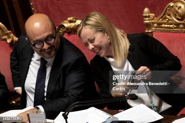 Italy's Prime Minister Giorgia Meloni and Minister for Culture Gennaro Sangiuliano laugh during a confidence vote at the Italian Senate, on October...