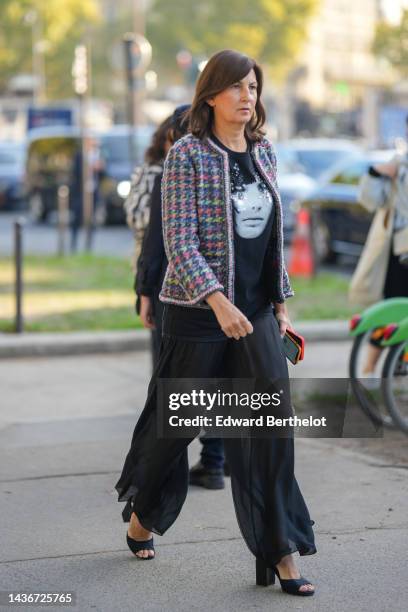 Guest wears a black with embroidered sequined and pearls t-shirt, a multicolored tweed pattern jacket, black large flowing pants, black block heels /...