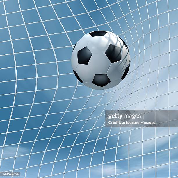 soccer ball flying into a goal - een doelpunt maken stockfoto's en -beelden