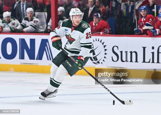 Jonas Brodin of the Minnesota Wild skates the puck during the first period against the Montreal Canadiens at Centre Bell on October 25, 2022 in...