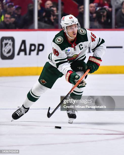Jared Spurgeon of the Minnesota Wild skates the puck against the Montreal Canadiens during the third period at Centre Bell on October 25, 2022 in...