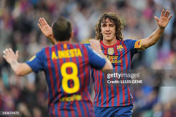 Barcelona's captain Carles Puyol celebrates with Barcelona's midfielder Andres Iniesta after scoring a goal during the Spanish league football match...